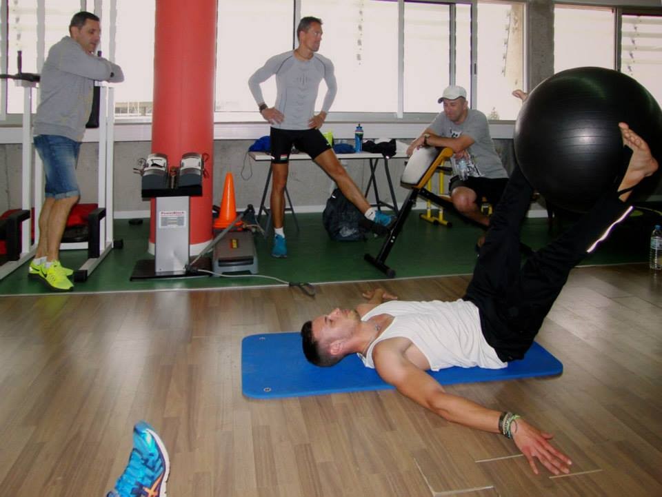 Indoor fitness training with athletes using exercise balls and stationary bikes during workout