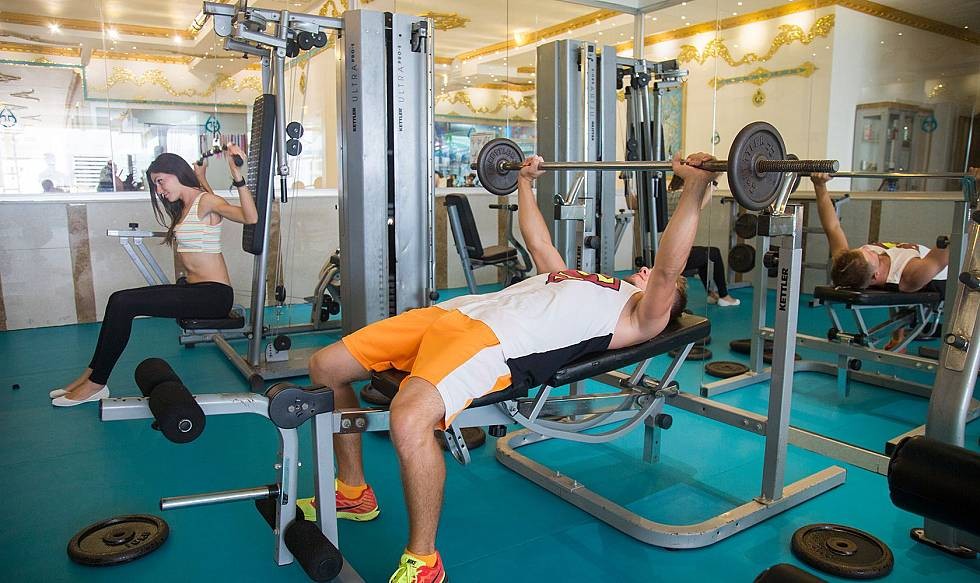 Gym workout area with weight machines and free weights