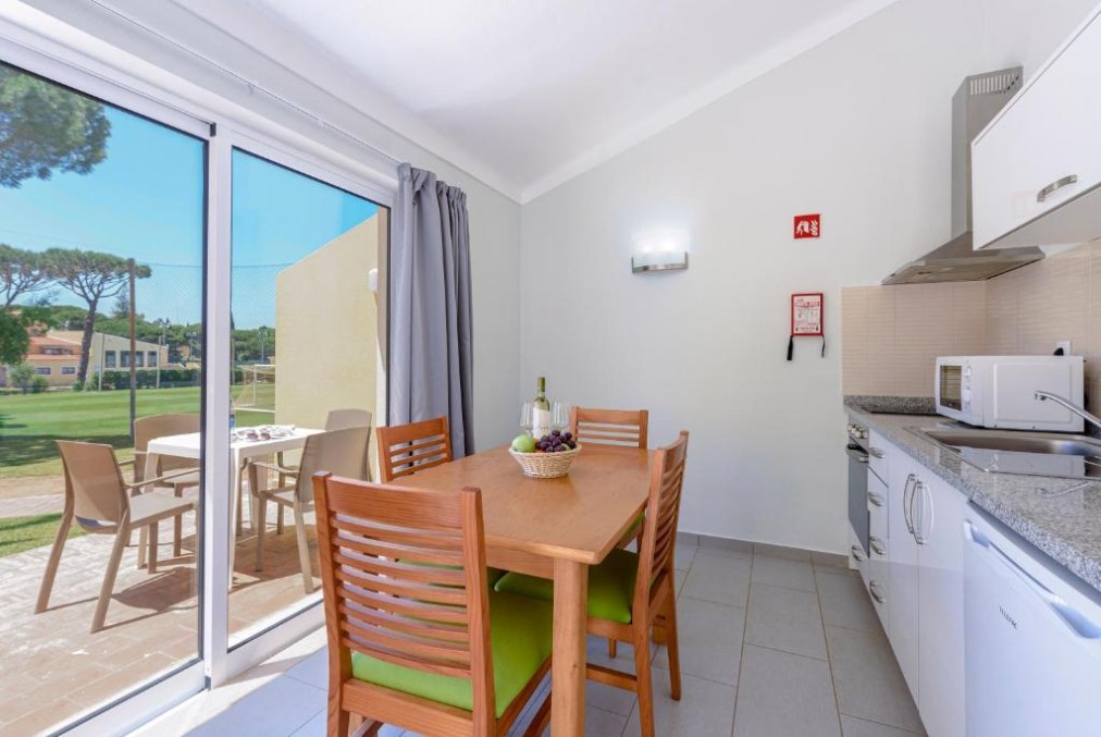 Kitchenette and dining area with sliding doors to a terrace.