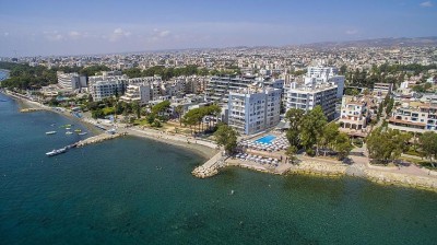 Aerial view of coastal city with beachfront hotels and clear blue sea