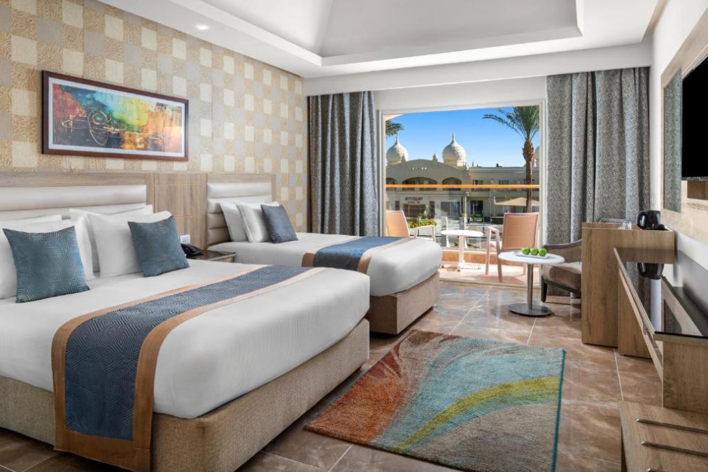 Twin room with two single beds and balcony seating, set for a training camp stay.