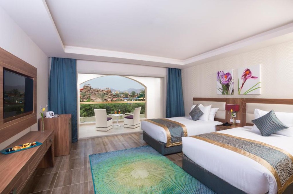 Spacious twin room with terrace seating and view over the resort, suitable for training camp rest.
