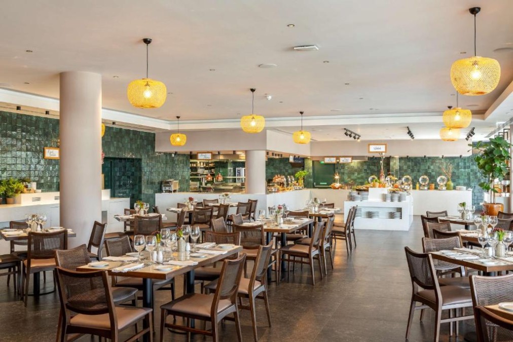 Restaurant dining room with buffet counters and set tables.