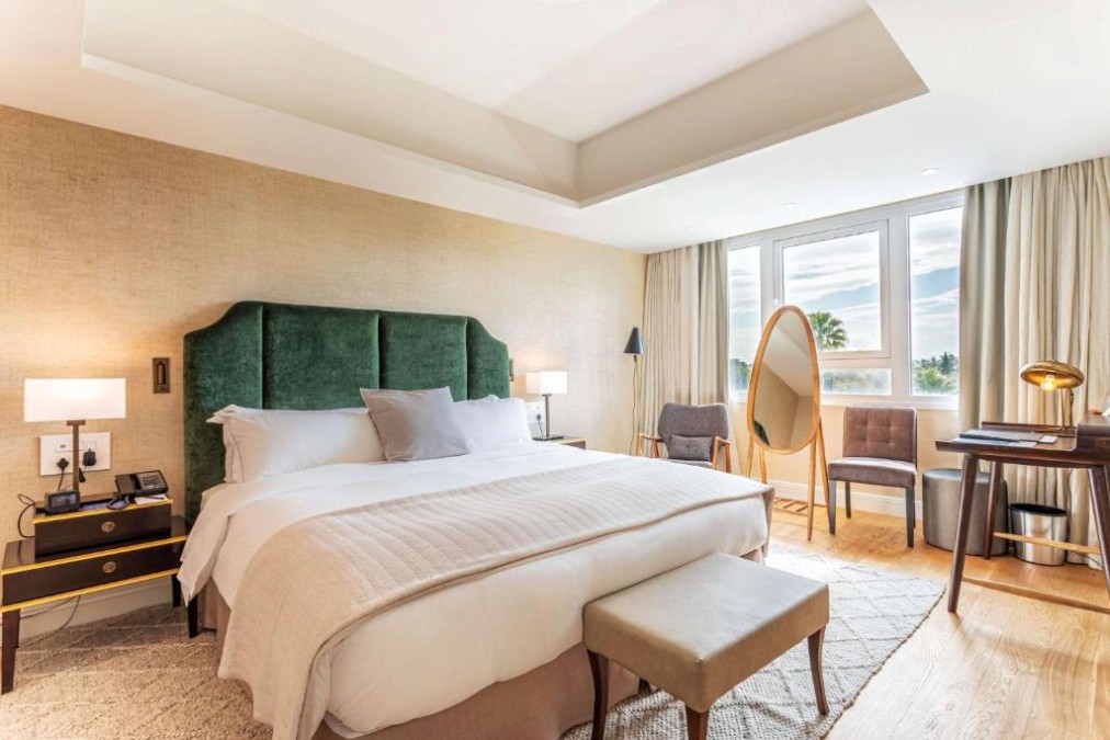 Premium room with king bed, work desk and freestanding mirror.
