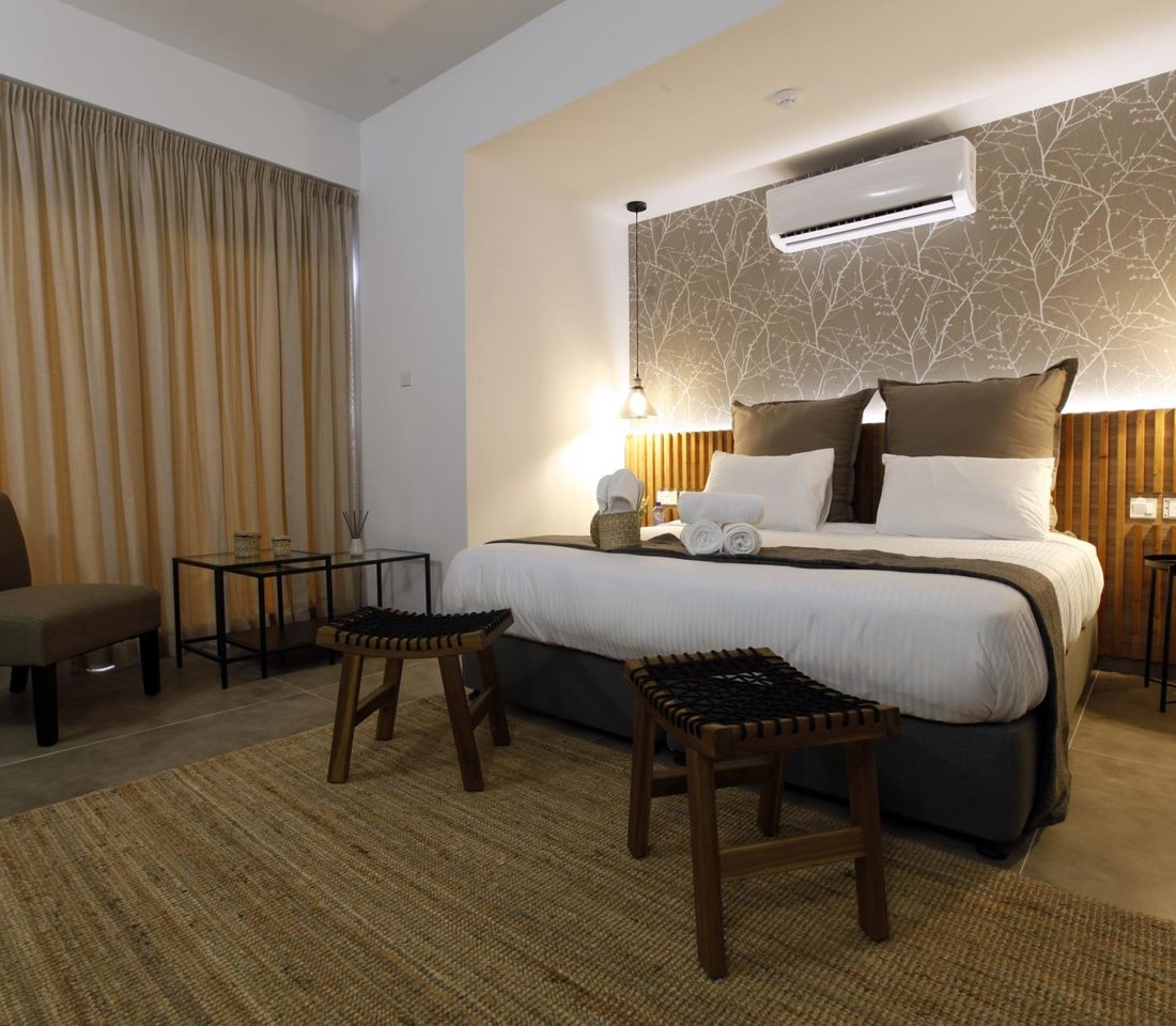 Bedroom with double bed, earthy decor, and soft lighting creating a calm atmosphere