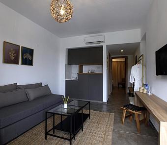 Living area with gray sofa, table, and minimalist design featuring neutral colors