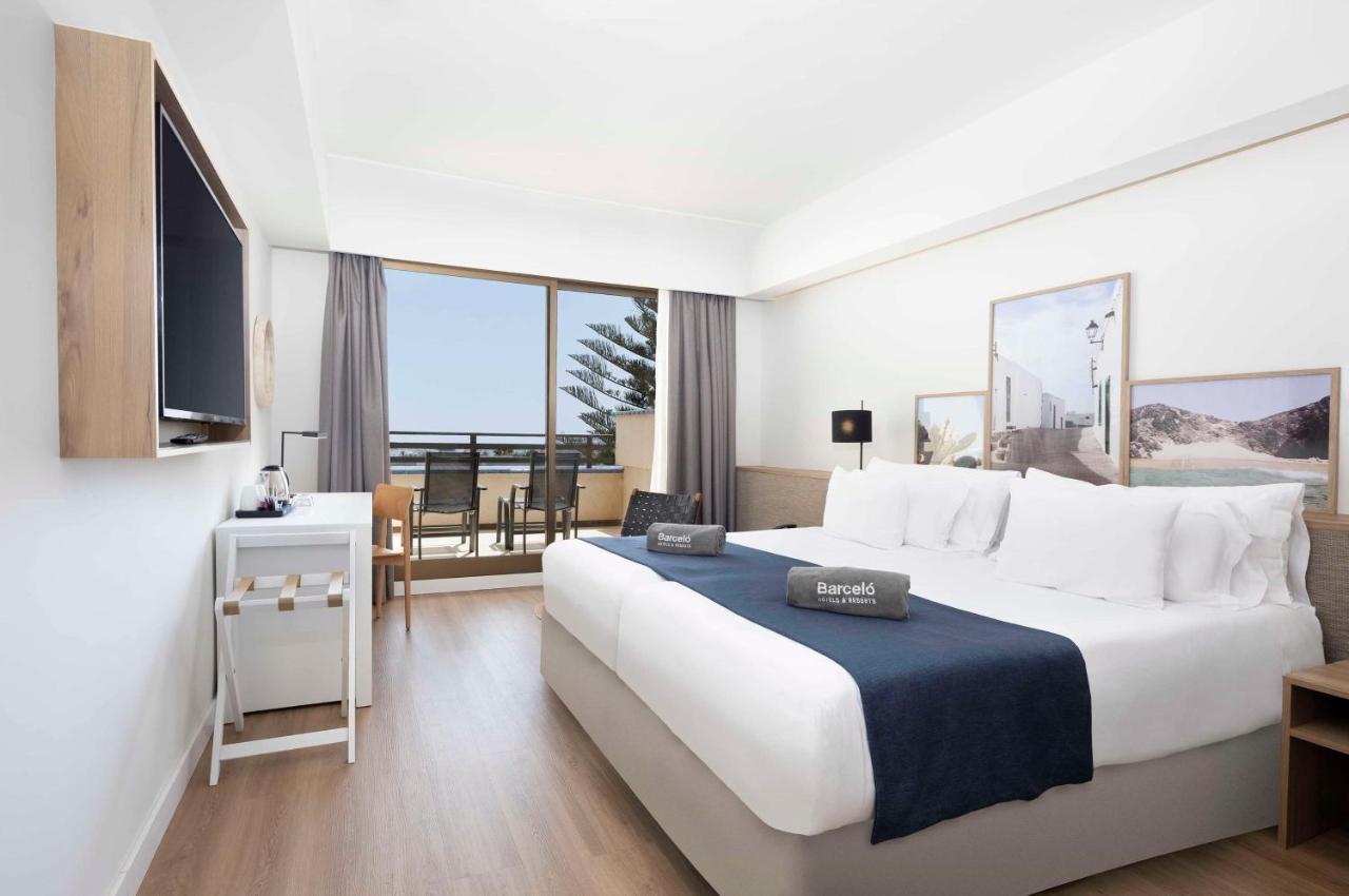 Modernes Gästezimmer mit Doppelbett, Schreibtisch und Balkonmöbeln.