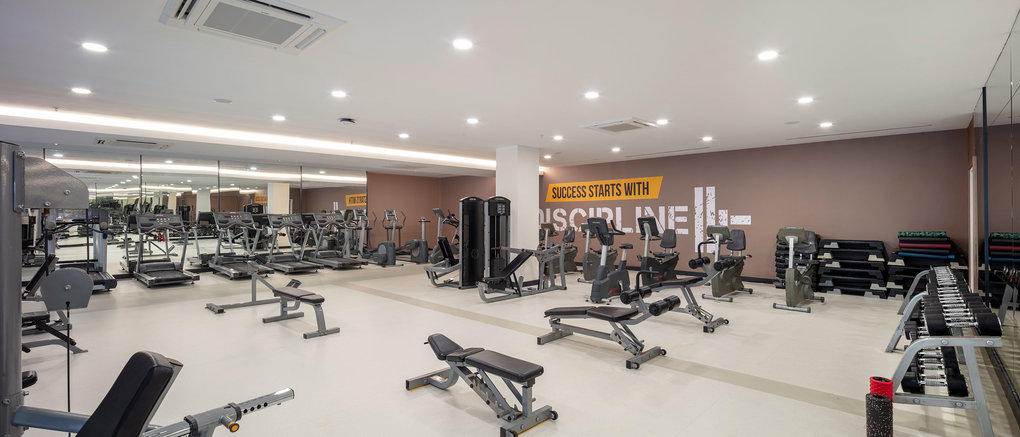Weight room with benches, dumbbells and training equipment for conditioning sessions.