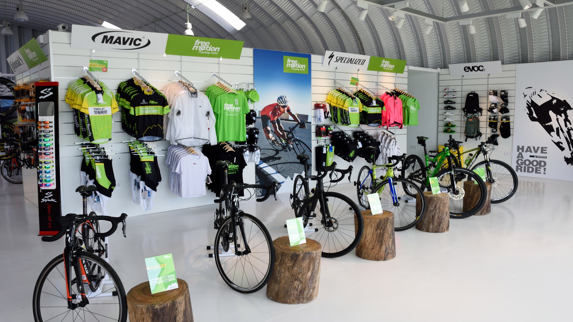Cycling shop displaying road bikes, jerseys, helmets and accessories for training camps.