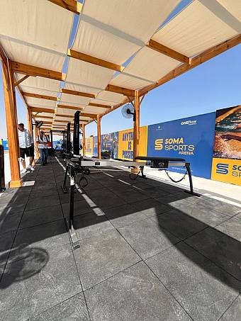 Outdoor covered workout area with benches and training equipment at sports camp