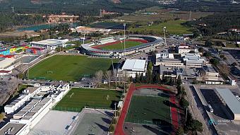 High aerial view of the Rio Maior sports complex with stadium, pitches, training areas and surrounding countryside.