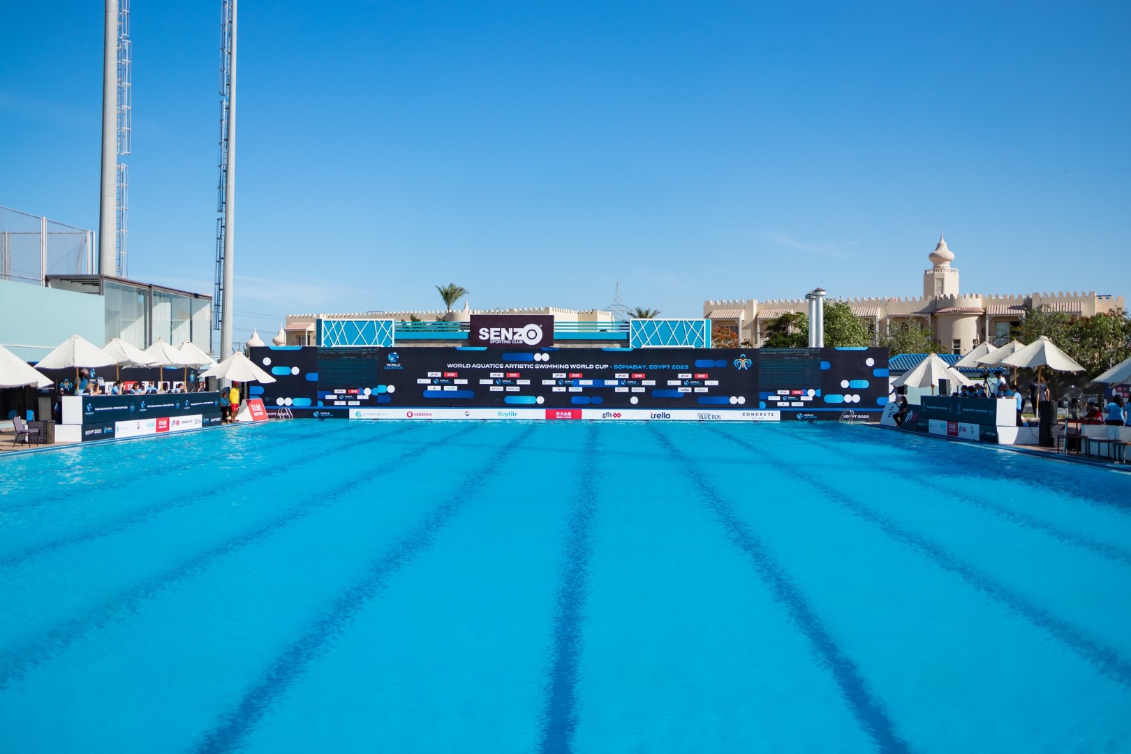 Outdoor Olympic swimming pool with diving platforms and banners for competition or training camp