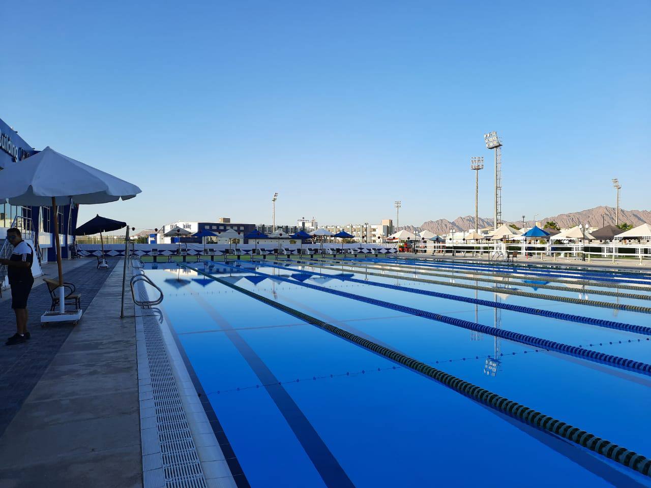 50m outdoor pool with lane lines and floodlights