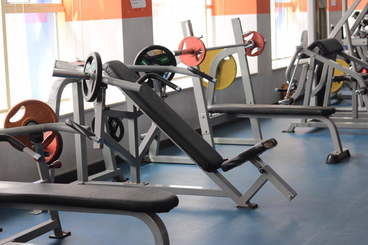 Bench press area with barbells and plates