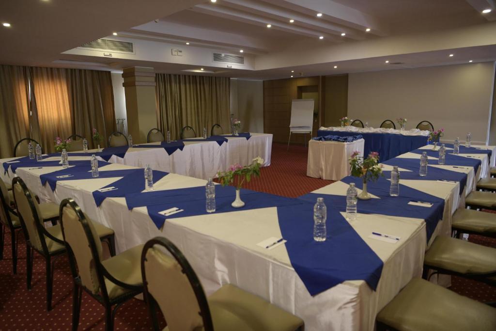 Conference room with U-shaped tables, water bottles, and flip chart.