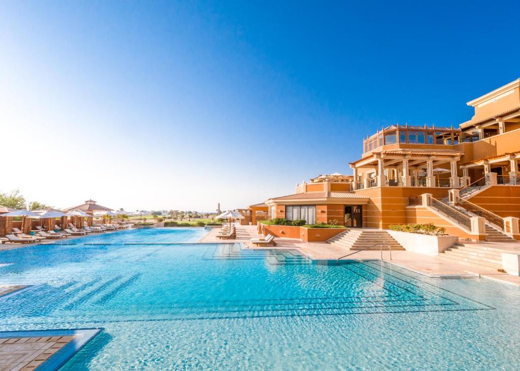 Large outdoor resort pool beside the main building, ideal for cooldown swims and leisure time
