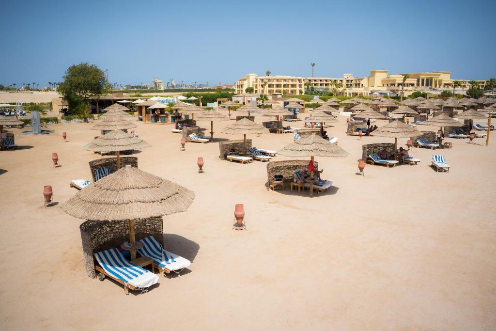 Wide sandy beach with sun loungers and straw umbrellas, perfect for rest days by the sea
