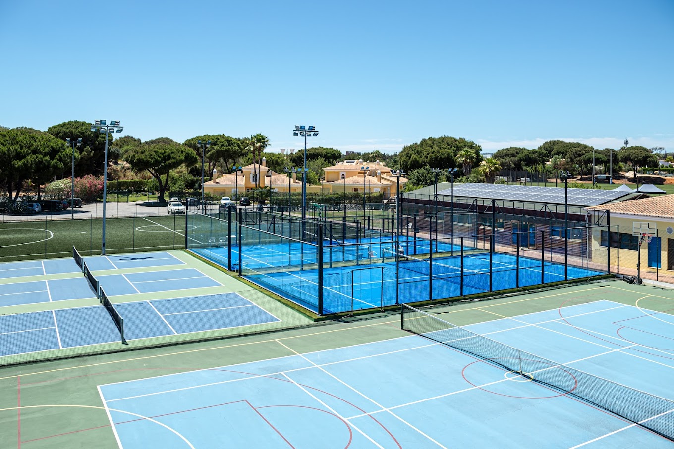 Wide view of tennis, padel and football facilities for a training camp.