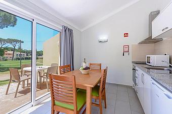 Kitchenette and dining area with sliding doors to a terrace.