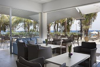 Indoor lounge with modern seating and glass doors opening to terrace