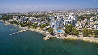 Aerial view of coastal city with beachfront hotels and clear blue sea