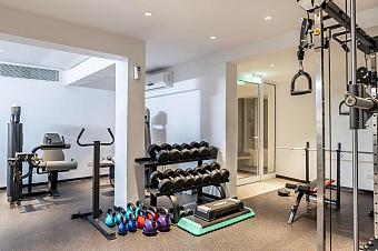 Gym with weights, kettlebells, machines, and space for athletes’ workout sessions or drills