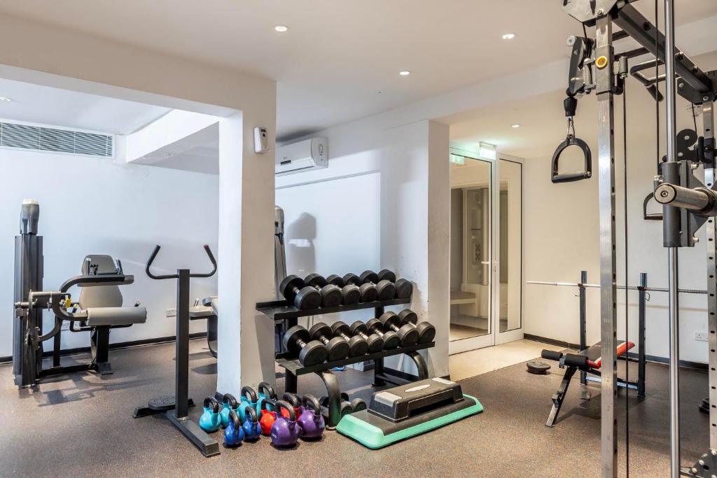 Gym with weights, kettlebells, machines, and space for athletes’ workout sessions or drills