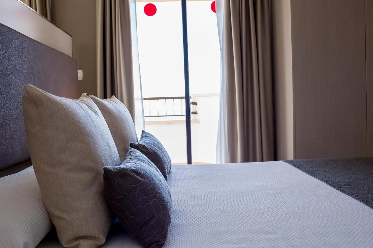 Close view of a double bed beside a balcony door.