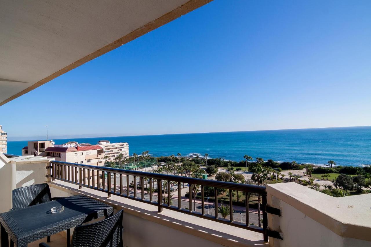 Private balcony with outdoor table and wide sea view.