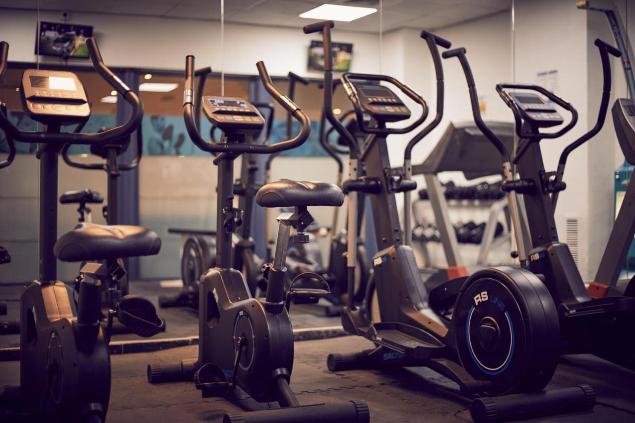 Fitness room with stationary bikes and ellipticals for cardio workouts.