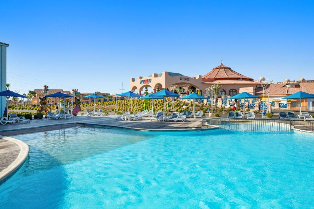 Outdoor pool with loungers and umbrellas at a family resort area