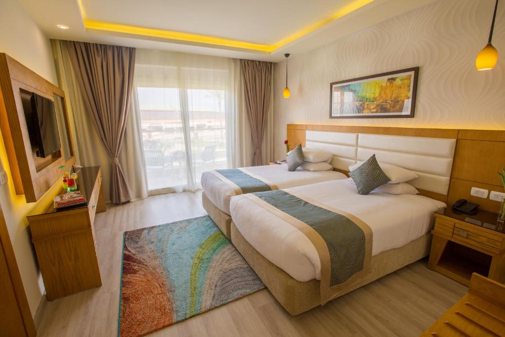 Spacious twin room with two single beds and balcony access, ideal for rest between training sessions.