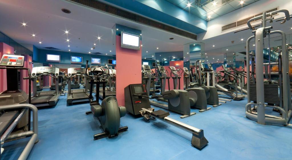 Gym area with treadmills, cardio machines, and mirrored walls for indoor workout.