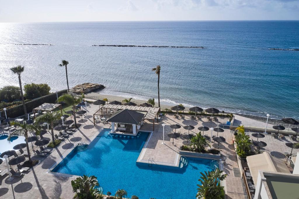 Aerial view of the pool terrace, beach and sea at the resort.