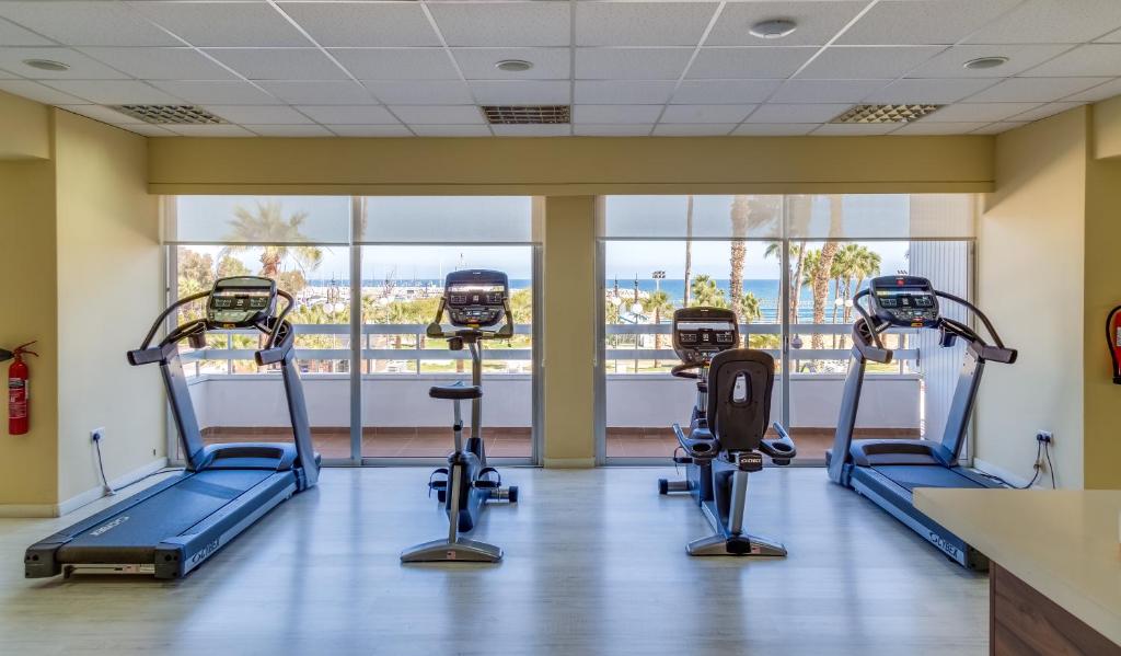 Bright gym with treadmills, bikes and sea views.