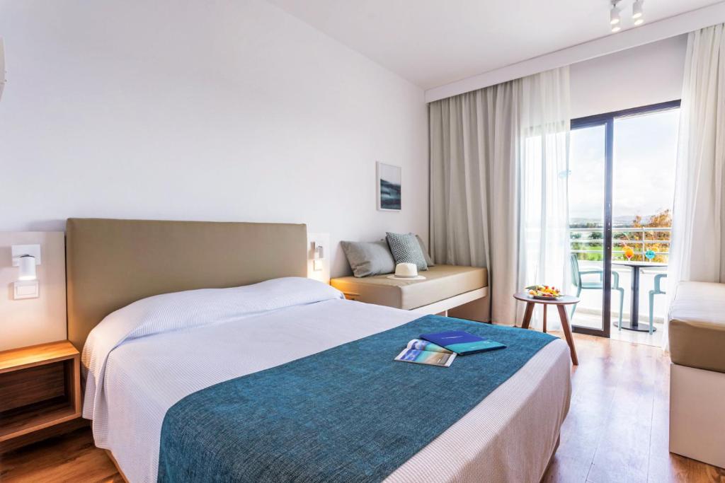 Guest room with double bed, sofa and balcony table.