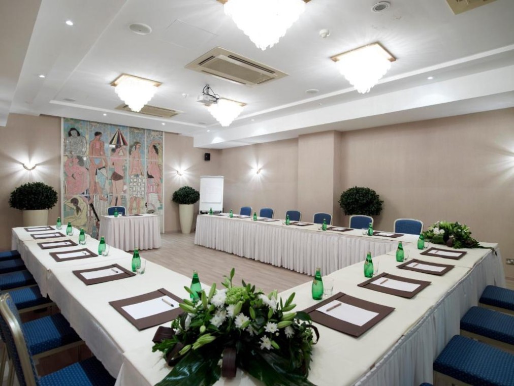 Salle de conférence en disposition en U pour réunions d'équipe et briefings.